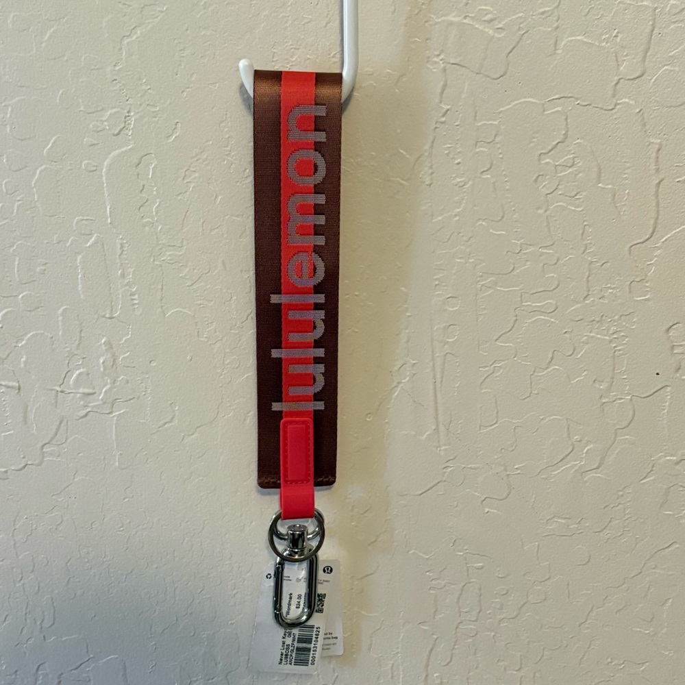 Lululemon Never Lost Keychain Word Mark NWT authentic ancp/glzp/wht